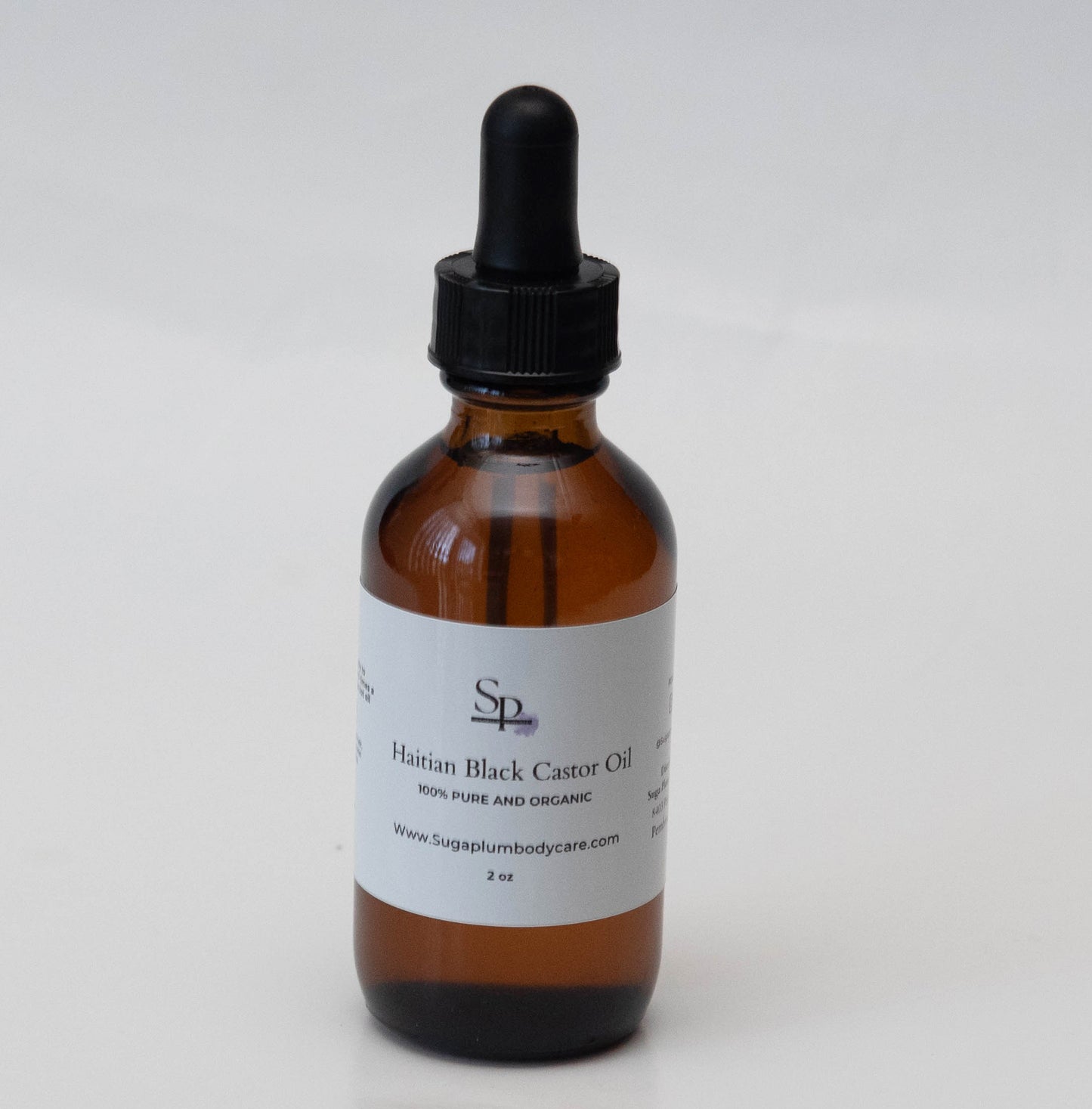 Brown glass bottle with black dropper on a white background