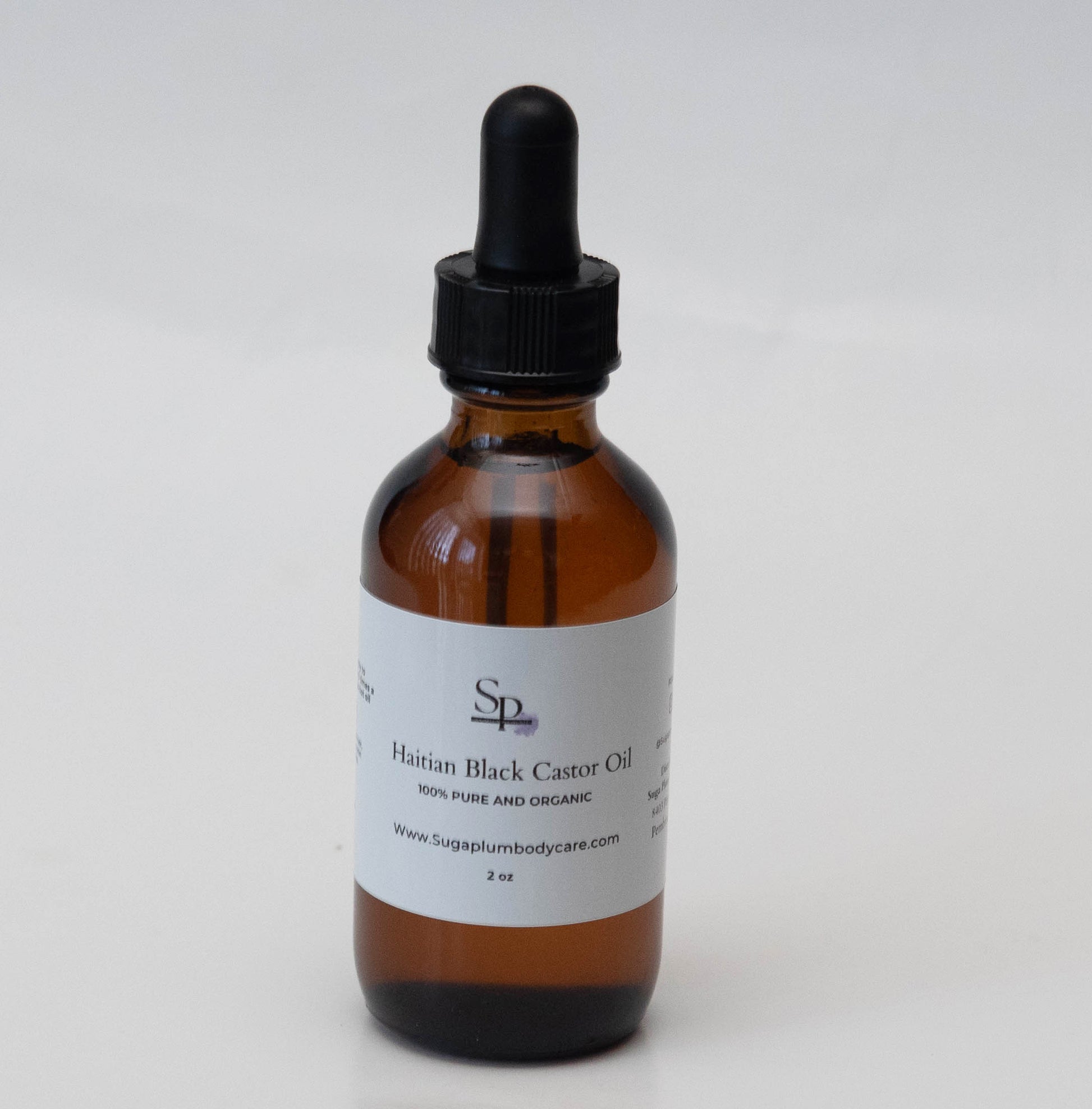 Brown glass bottle with black dropper on a white background